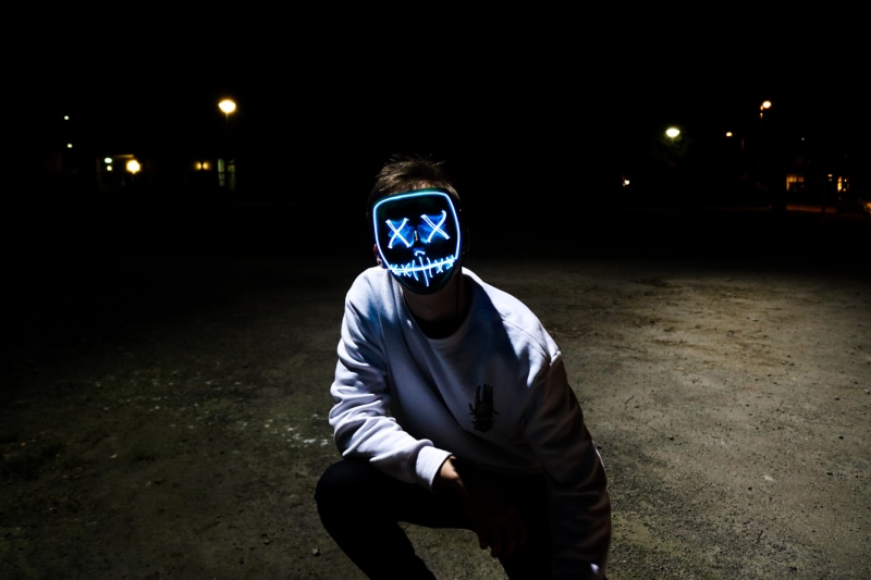 real people, obscured face, white, black, illuminated, looking at camera, front view, three quarter length, leisure activity, light painting, purge, street