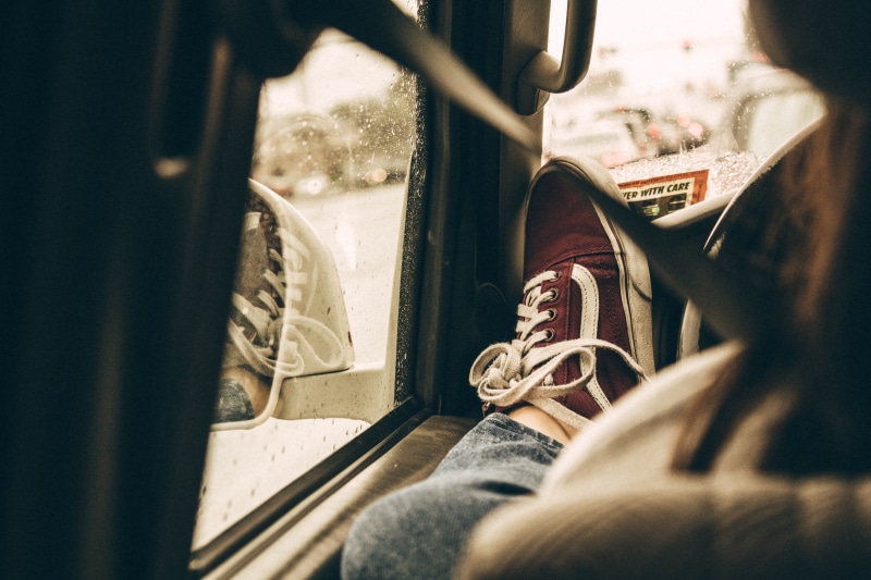 reflection, top, passenger, rainy day, sitting, shoe, moody, drive, one person, human body part, body part, window, indoors, mode of transportation, travel