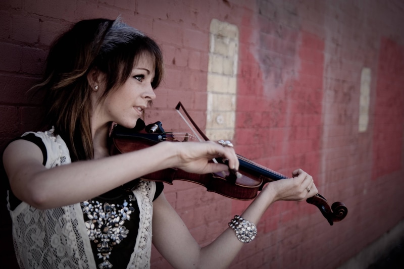 violin, hairstyle, lifestyles, looking, women, musical instrument, Lindsey Stirling, beauty, casual clothing, gun, bracelets, hair, wall - building feature