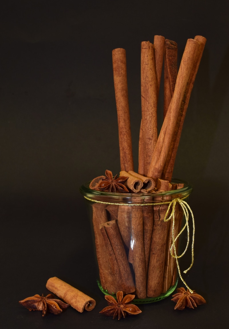 no people, aroma, spice, anise, decoration, container, black background, food and drink, brown, bake, 5K, cinnamon, ingredient, cinnamon sticks, table