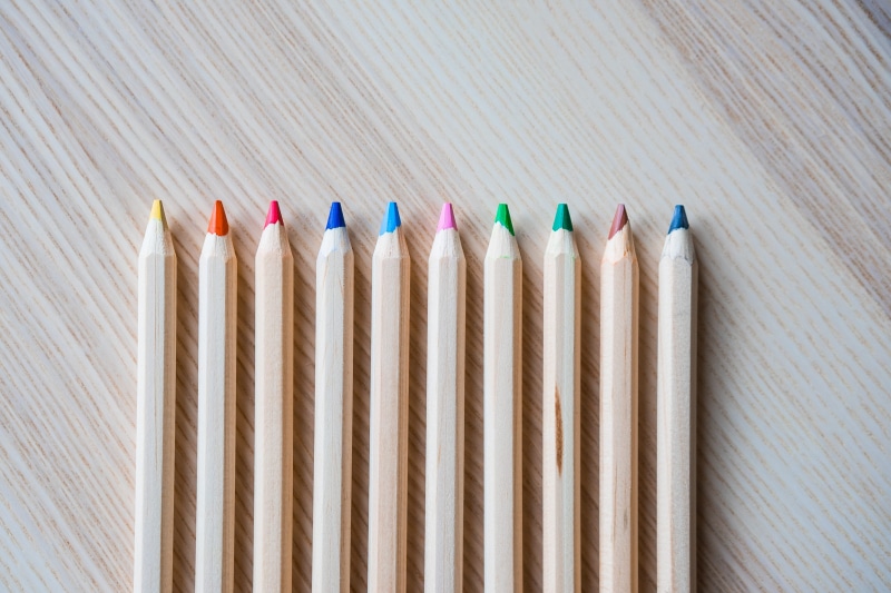 colored pencil, crayon, group of Objects, wood - Material, Row, side by side, wood, close-up, writing instrument, large group of objects, backgrounds, table