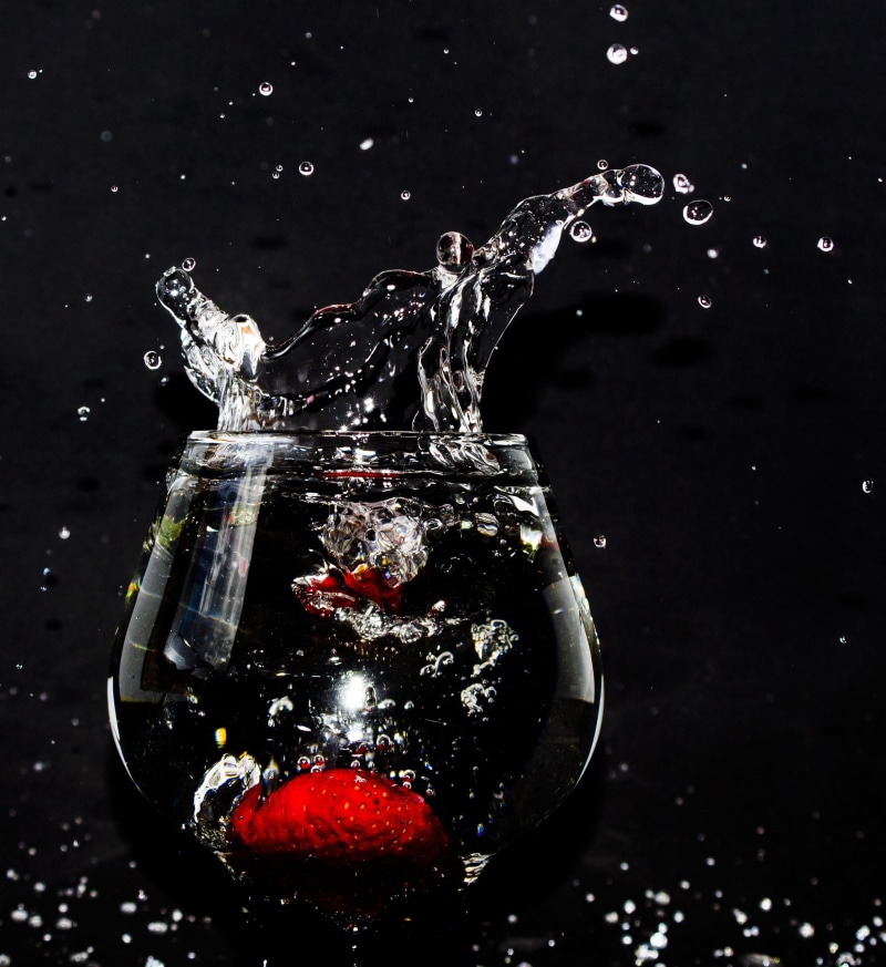 drinking glass, glass, black background, high-speed photography, glass - material, close-up, no people, food, still life, macro, red, fluid, liquid, clear