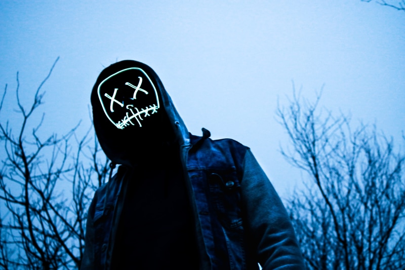 outdoors, jacket, sign, trees, lens, casual clothing, upside, grey, plant, eyes, mask, nature, creepy, unrecognizable person, one person, clouds, smile