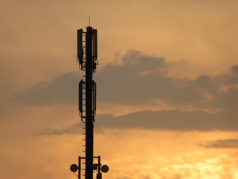 steel, low angle view, tower, mobile phone mast, global communications, day, radio mast, cloud - sky, connection, transmission, orange color, radio relay