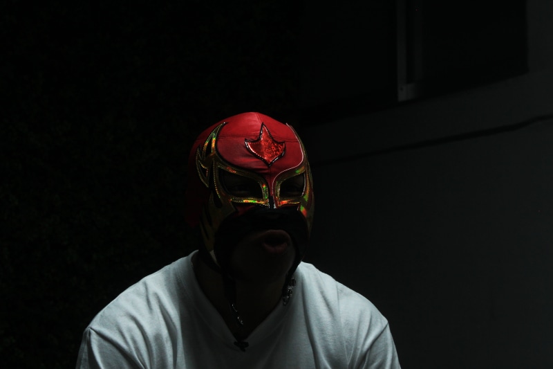 shirt, one Person, lucha libre, standing, lifestyles, mask - Disguise, black background, studio shot, dark, front view, Roja, man, mask, looking at camera