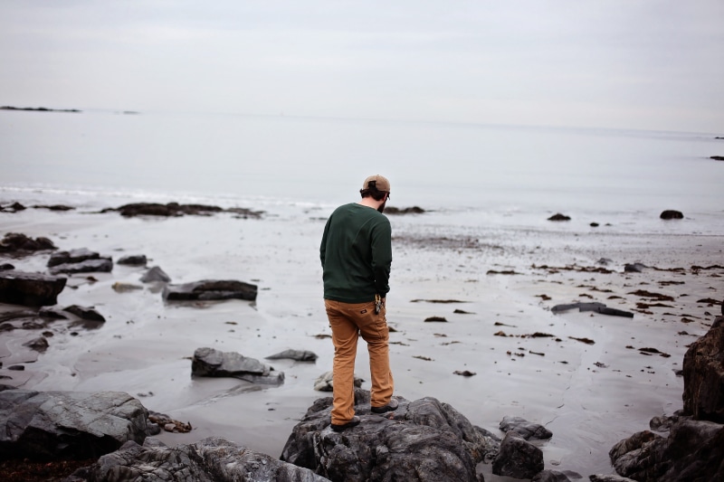 ocean, horizon, real people, beach, land, rock, outdoors, one person, seashore, nature, tide, sky, solid, leisure activity, relaxation, 5K, person, rear view