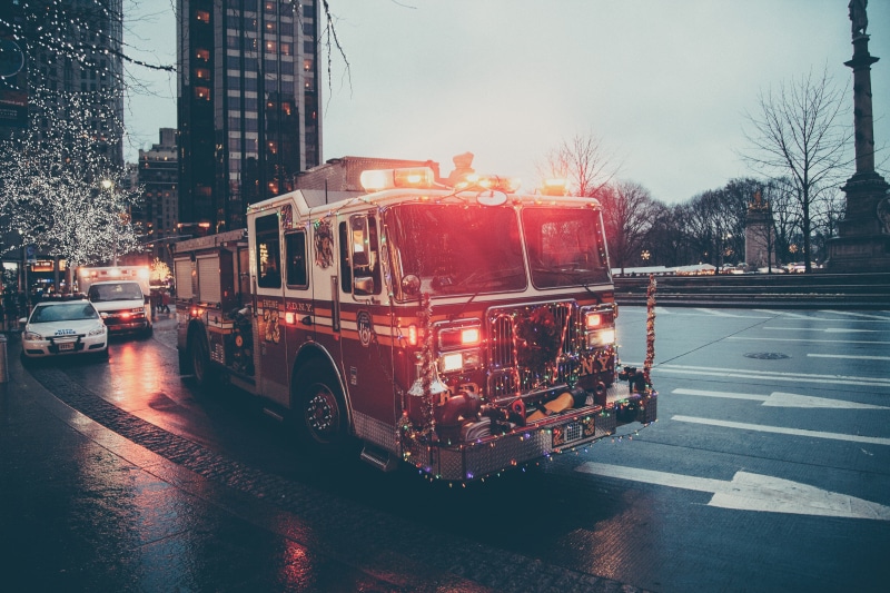 city, roadway, sign, sirens, built structure, land vehicle, 5K, wet, ambulance, city street, car, communication, transportation, followed, concrete, architecture