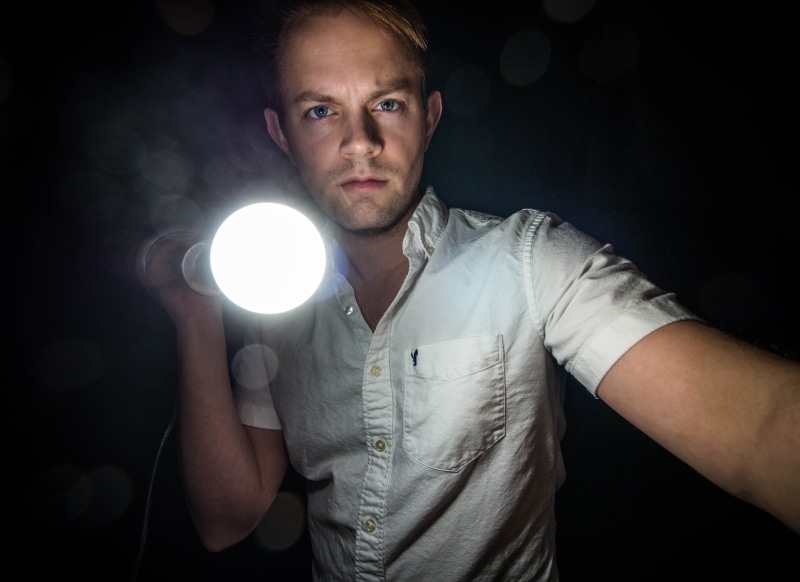 4K, caucasian Ethnicity, contemplation, guy, looking at camera, waist up, dark, indoors, man, hairstyle, lighted, casual clothing, caucasian, mid adult