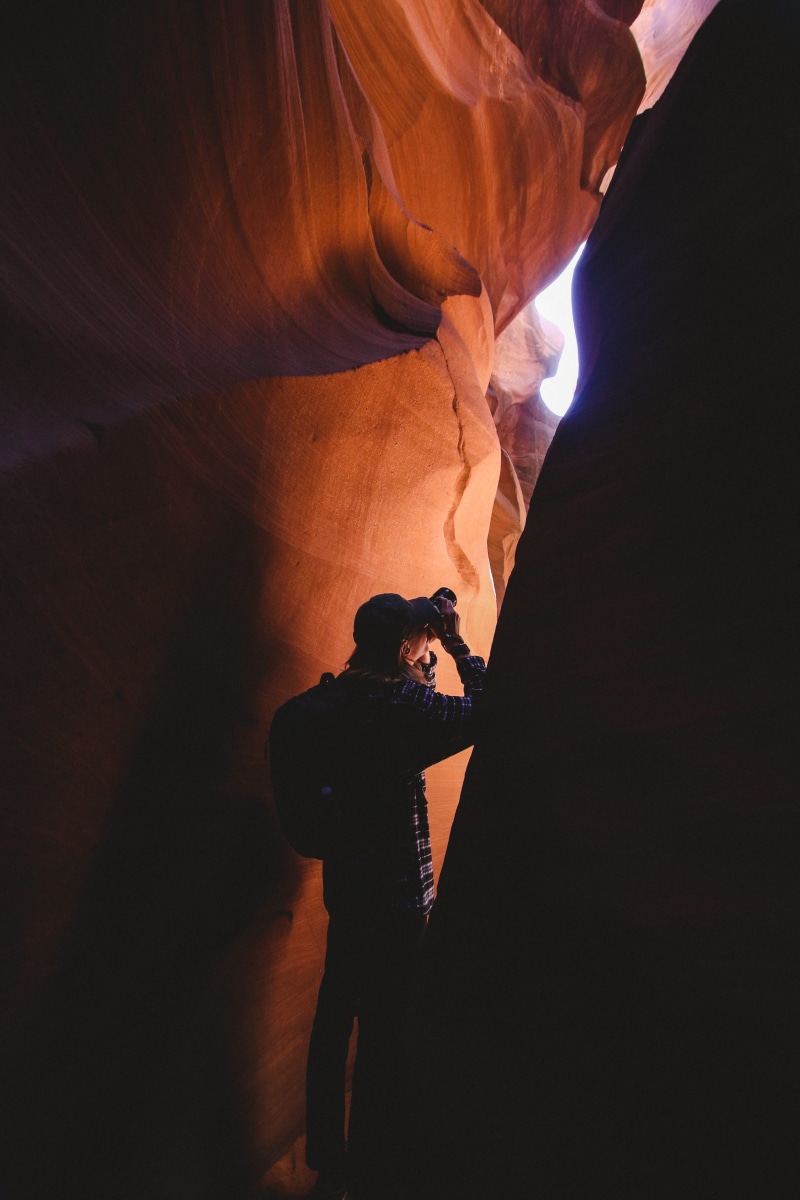 flare, lifestyles, nature, eroded, 5K, men, rock - object, inside, person, travel, rocks, daylight, camera, one person, real people, light, non-urban scene