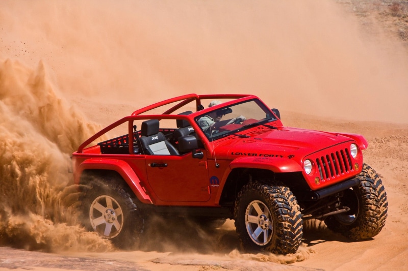 land, motor vehicle, land vehicle, sports utility vehicle, mode of transportation, day, adventure, car, travel, wheel, red, wrangler, motion, people, outdoors