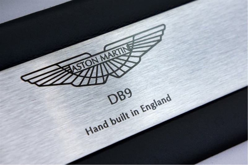 Aston Martin DB9, table, 720P, handwriting, finance, no people, western script, business, indoors, black color, emblem, text, high angle view, car, aston
