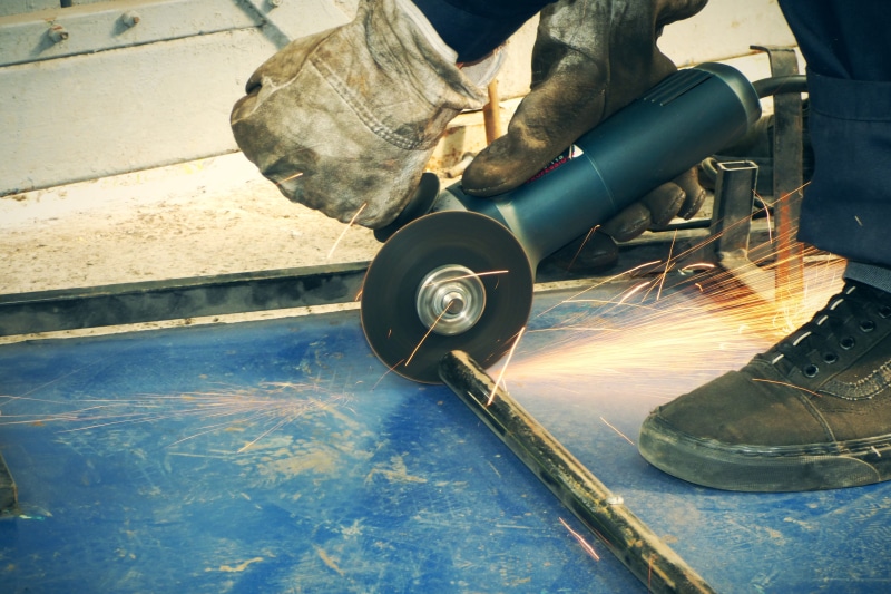 one person, indoors, worker, blurred motion, real people, emery, occupation, human limb, hand, equipment, welding, iron - metal, spark, men, angular, work