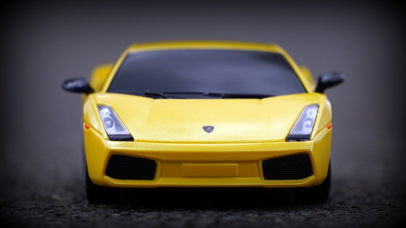 motor vehicle, plastic, black, scale, model, ground, wealth, cast, lamborghini, outdoors, mode of transportation, transportation, still, indoors, yellow