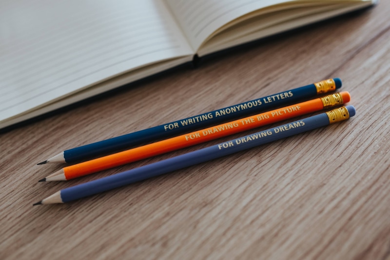 Notebooks, colourful, crayon, studying, focus on foreground, paper, notebook, indoors, no people, table, education, diary, journal, wood - Material, pencil