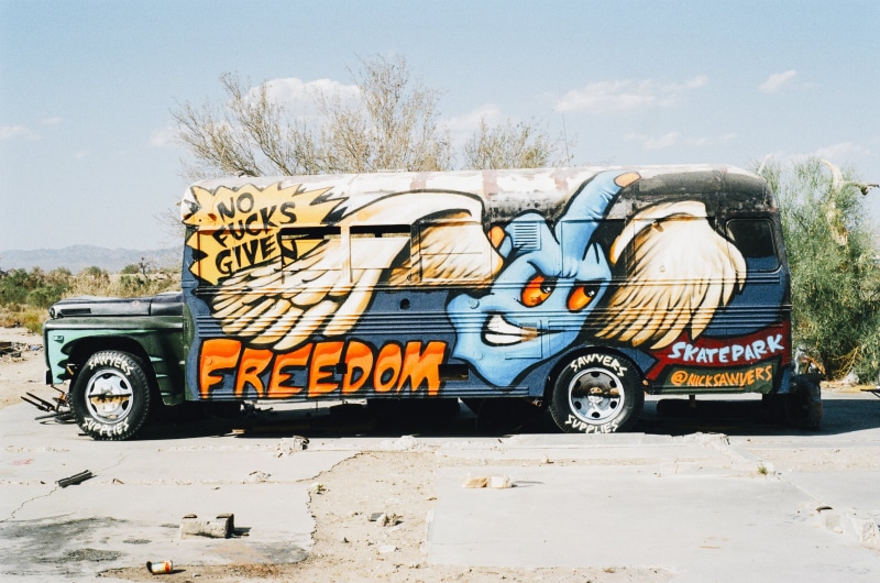 graffiti, brown, transportation, mode of transportation, paint job, white, road, skatepark, day, no people, truck, rebellious, nature, clear, blue, wheel
