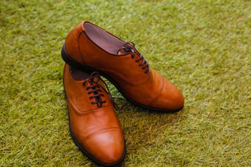 fashion, two objects, shoelace, close-up, men, s, compatibility, high angle view, sport, brown, nature, boot, green, pair, grass, land, footwear, absence