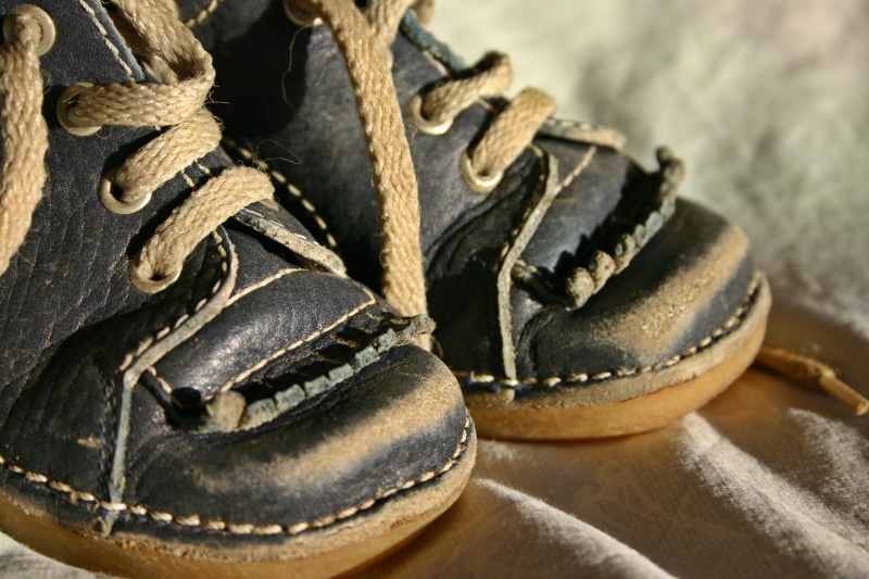 protection, blue, day, clothing, childhood, brown, worn, no people, sport, small child, baby shoes, learn to walk, snow, single object, lace - fastener