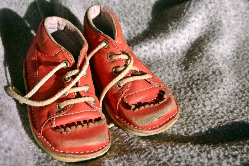 fashion, flooring, memory, two objects, small child, clothing, pair, indoors, high angle view, old shoes, shoe few, focus on foreground, old, canvas shoe