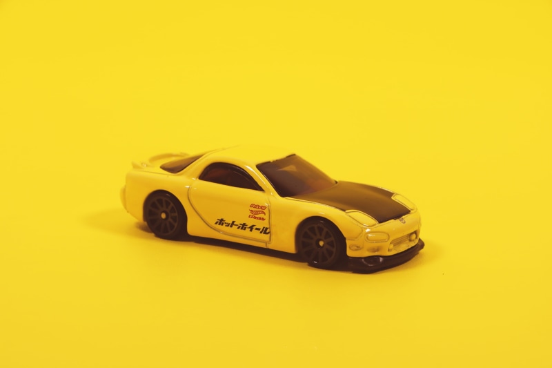 toy car, drive, indoors, transportation, transportation system, colorful, vehicle, land vehicle, play, speed, wheels, miniature, no people, coupe, kids