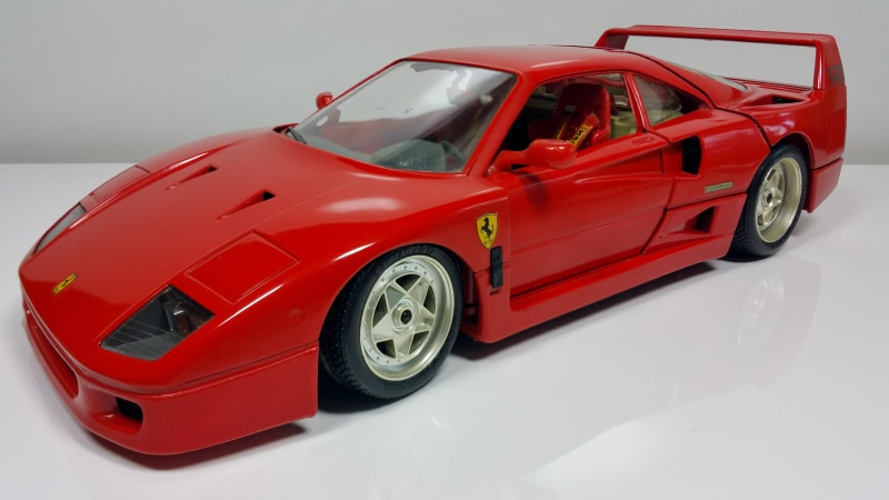 cast, car, model car, white color, red, Auto, model, no people, white, 5K, Ferrari, plastic, indoors, shiny, studio shot, motor vehicle, white background