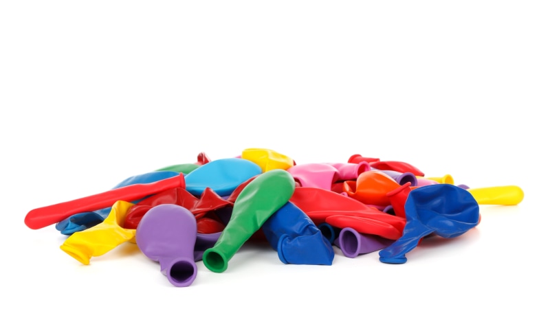 large group of objects, still life, bright, copy space, paper, occasion, deflated, balloon, fun, white Background, colorful, colored, colors, pile, office