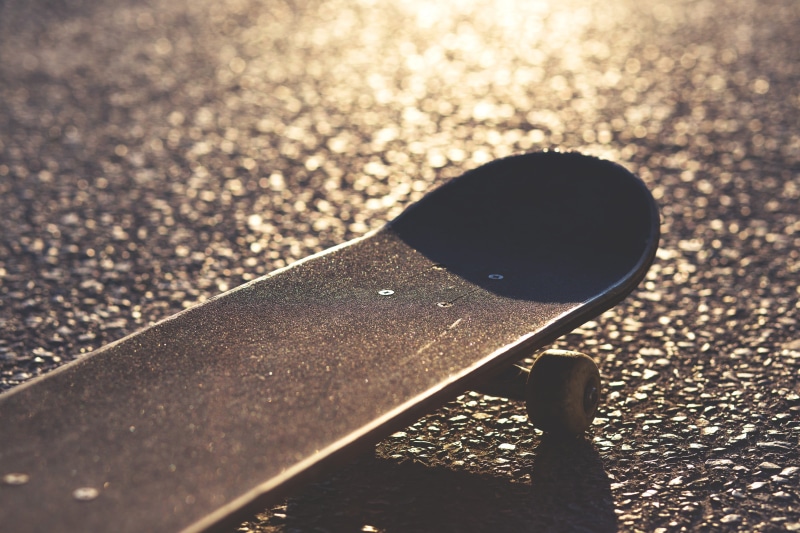 wheels, single object, sports equipment, high angle view, thrasher, day, water, road, no people, things, close-up, skate, light, 2K, city, shadow, transportation