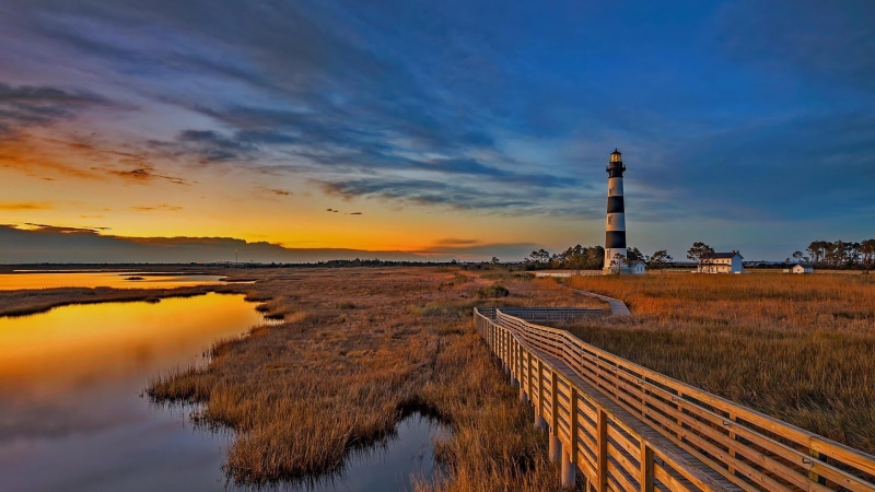 beauty in nature, cloud, guidance, no people, built structure, bodie island lighthouse, evening, wetland, sky, lighthouse, protection, scenics - nature
