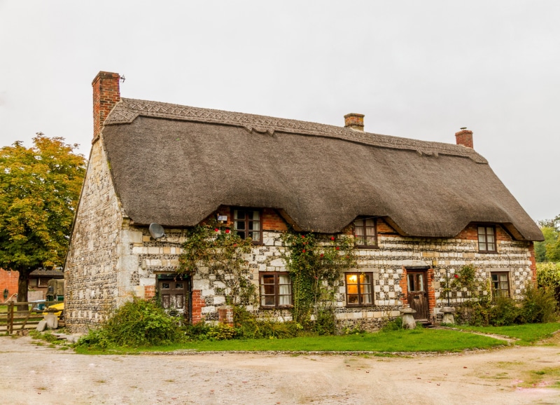 outdoors, bungalow, country, facade, no people, landscape, residential district, thatch roof, building exterior, history, photo, architecture, rural scene