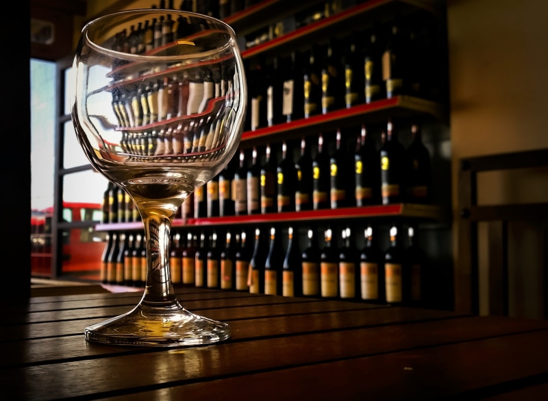 vine, wood - material, no people, red wine, decoration, still life, refreshment, liquor store, celebration, indoors, alcohol, wooden, drink, container