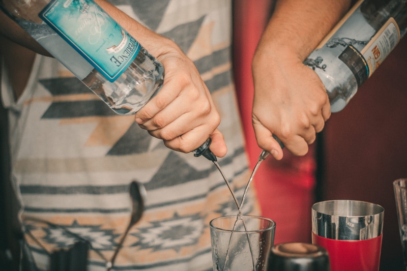 people, preparing food, beer, hand, alcohol bottles, food, party, pub, food and drink, pour, holding, occupation, midsection, bar, hands, adult, liquid