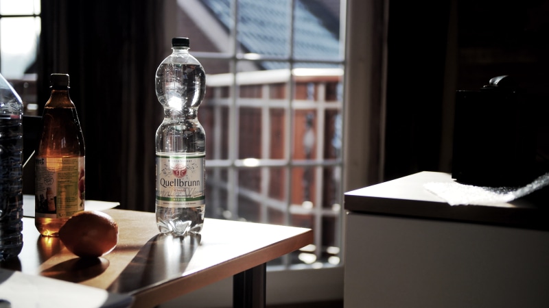 bottle, household equipment, brown, indoors, close-up, plastic, lights, alcohol, bar counter, bar - drink establishment, bottles, no people, wooden, glass items
