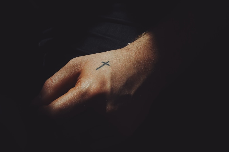 body part, human limb, copy space, close-up, cross, wrist, black, indoors, black background, selective focus, kite, church, lifestyles, real people, weaponry