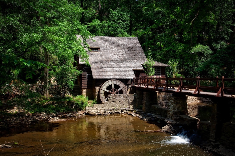 waterfront, architecture, connection, motion, reflection, outdoors, arch bridge, growth, nature, watermill, wood - Material, United States, bridge, water