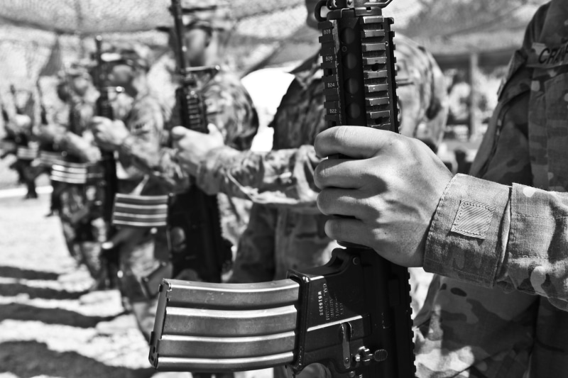 musical equipment, arts culture and entertainment, real people, group of people, men, projectiles, government, army, combat, market, rifle, camouflage