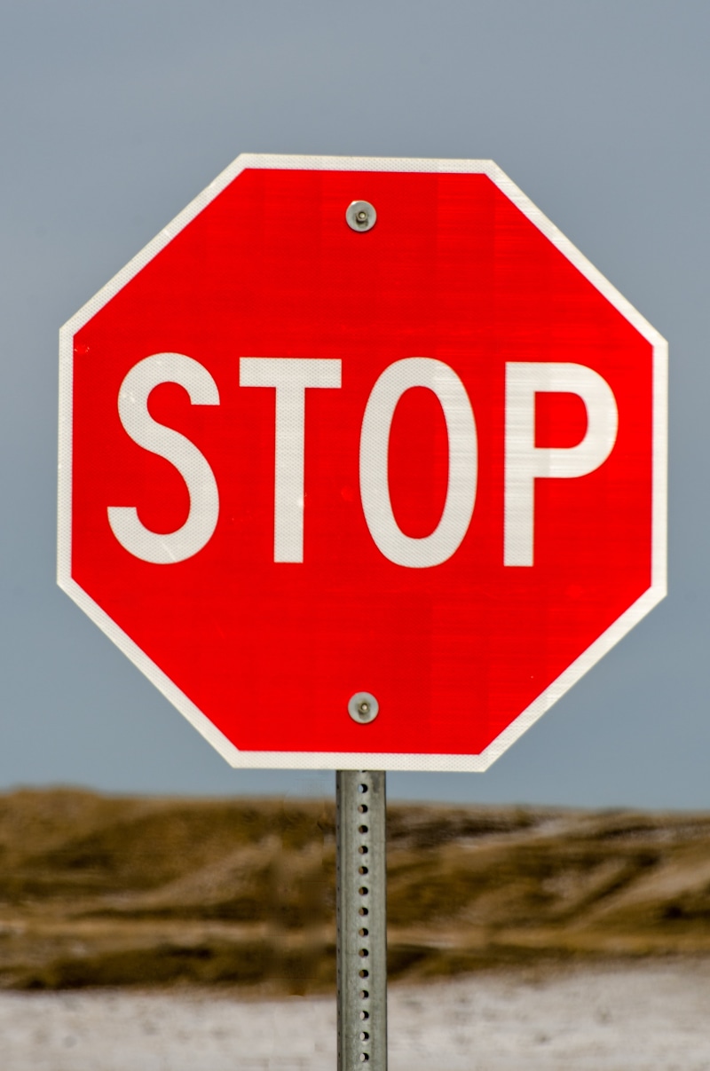 stop sign, capital letter, law, road sign, sky, metal, western script, roadside, close-up, street, halt, forbidden, communication, symbol, traffic, stop