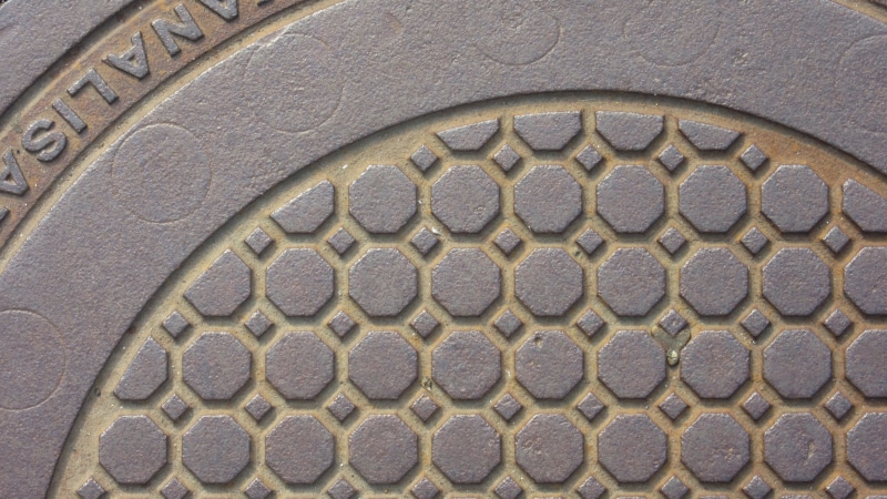 building exterior, architecture and art, circle, cast iron, pattern, hard, textured, octagons, geometric shape, building, manhole cover, low angle view