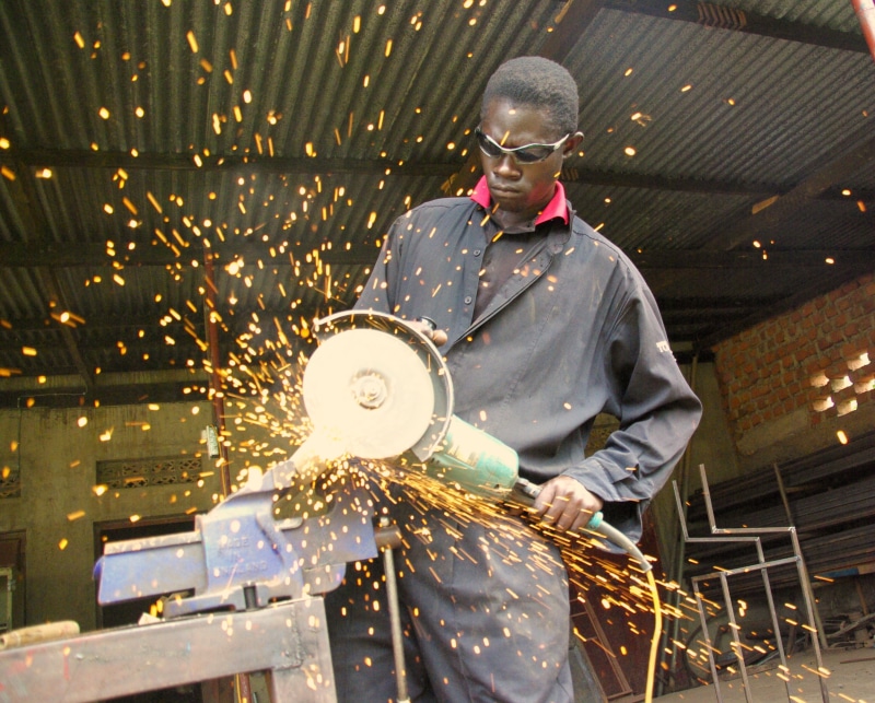 grinder, saw, people, men, one person, cutting, security, work, danger, indoors, sparks, worker, green, industry, holding, craftsperson, energy, three quarter length