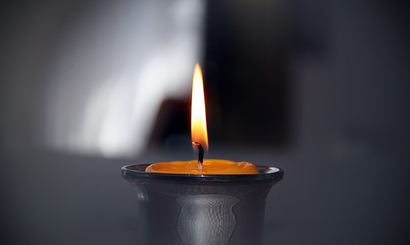 studio shot, indoors, smoke - physical structure, photography, nature, candela, fire - Natural Phenomenon, peace, orange color, motion, candlelight, focus on foreground