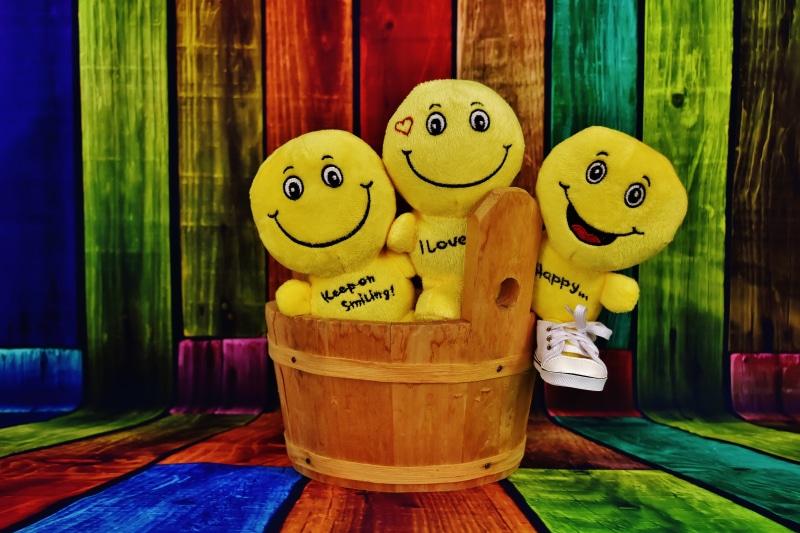 color, three, wooden, representation, smilies, toys, indoors, smiley, brown, no people, plush, laugh, still life, faces, close-up, emotions, smiling, yellow