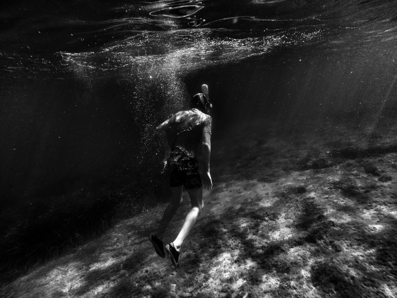 underwater, undersea, sea, grayscale, swimming, sport, real people, motion, exploration, ocean, men, nature, diving, shadow, outdoors, day, adventure, dark