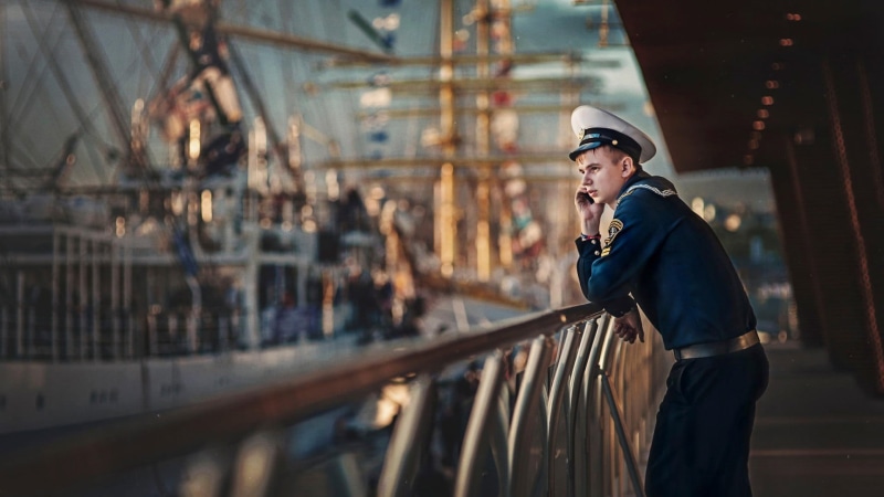 adult, sailor, architecture, transportation, men outdoors, one person, office, hat, blue, depth of field, men, side view, hardhat, standing, railing, business
