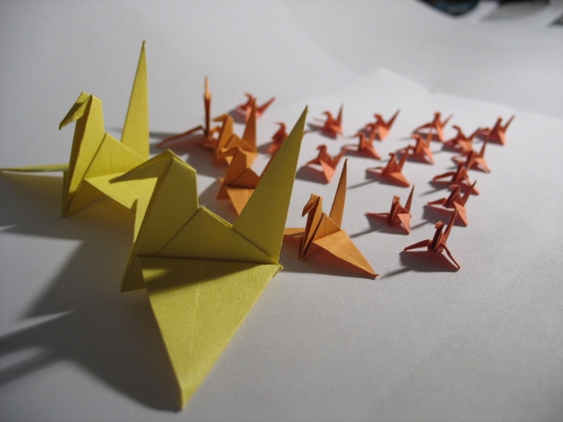 large group of objects, studio shot, yellow, paper cranes, orange, shape, art and craft, no people, craft, paper boat, creativity, gray background, pencil