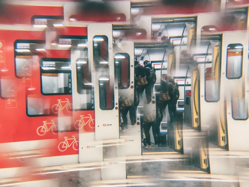 blurred motion, train - vehicle, suit, bus stop, transportation, airport, overcoat, meal, pedestrian, coat, subway train, food, women, real people, vehicle interior
