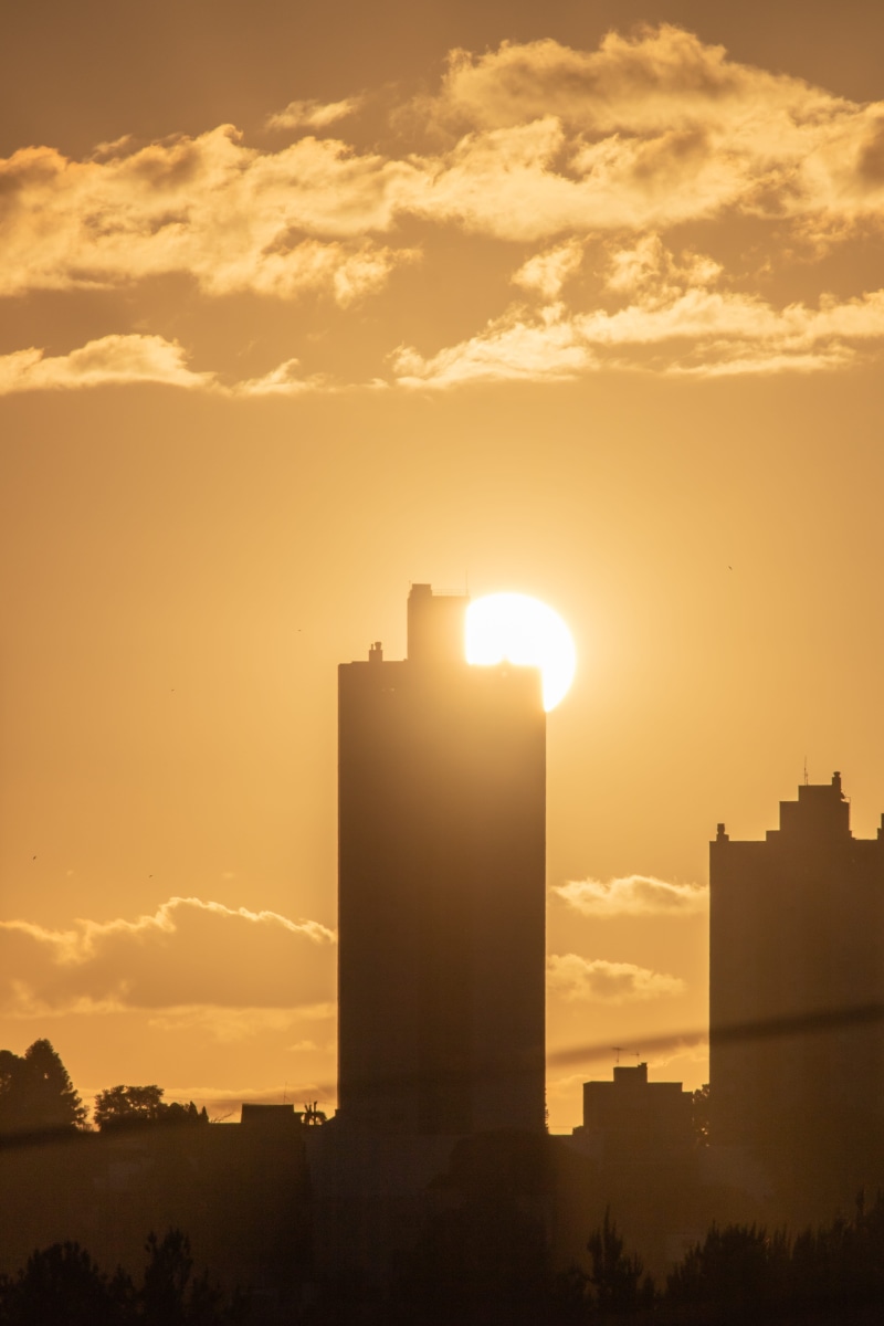 red sky, buildings, history, office building, high, cloud - sky, hour, golden, sunlight, the past, flare, outdoors, sun, built structure, dawn, sunset