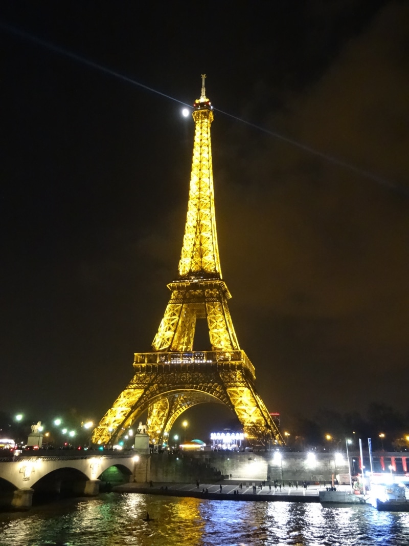 architecture, travel, nature, glistening, sky, tower, building exterior, eiffel tower, ray of light, tourism, river, built structure, tall - high, full moon