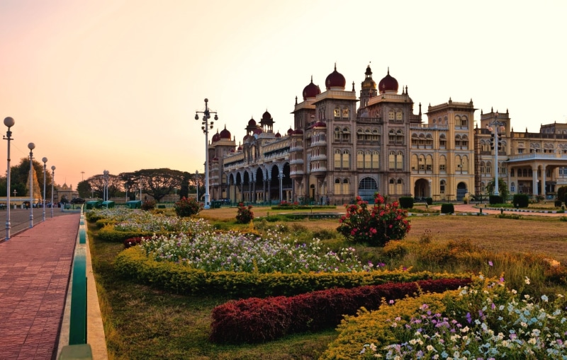 building, formal garden, built structure, building exterior, ornamental garden, flower, plant, architecture, Mysore, India, incidental people, Mysore Palace