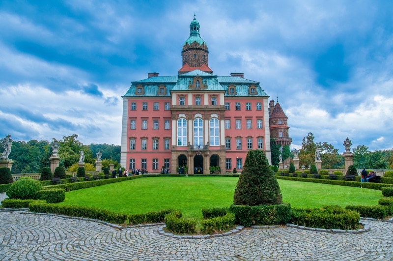 building Exterior, day, history, cloud - sky, nature, wall, travel Destinations, sculpture, building, outdoors, hedge, travel, plant, government, cultures