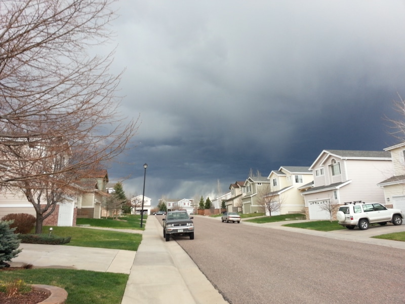neighborhoods, building, building exterior, plant, road, city, neighborhood, extreme weather, grass, house, mode of transportation, cloud - sky, nature