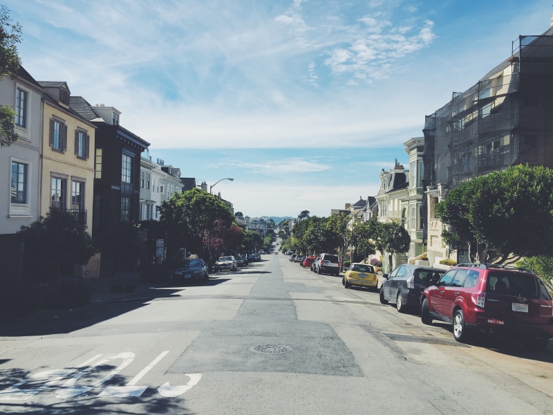outdoors, 2K, city, sunny, motor vehicle, no people, direction, land vehicle, transportation, car, city street, architecture, building, houses, cars, nature