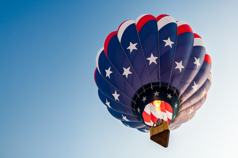 American flag, transportation, adventure, parachute, multi colored, sky, leisure activity, flying, flag, clear sky, extreme sports, day, ballooning festival